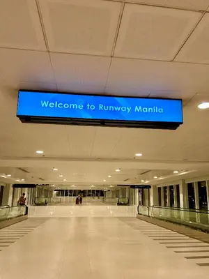 a welcome to runwaymite sign in a building at Condotel Across Naia T3 at ONE PALM TREE VILLA CLUSTER B in Manila