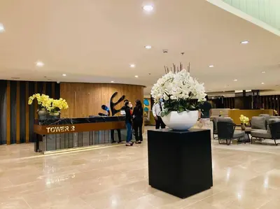 a lobby with a vase of flowers on a table at Philippine International Convention Center 676 DYNASTEL SHORE in Manila