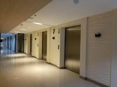 a hallway of a building with doors and a hallwayngthngthngthngth at Philippine International Convention Center 676 DYNASTEL SHORE in Manila