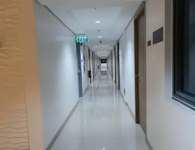 an empty hallway in a building with a green street sign at SHORE RESIDENCES HOTEL Staycation 621 Dynastel in Manila