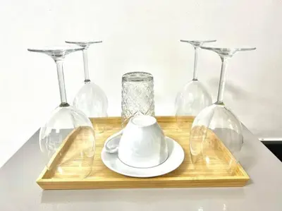 a wooden tray with four wine glasses and a teaucer at SHORE RESIDENCES HOTEL Staycation 621 Dynastel in Manila