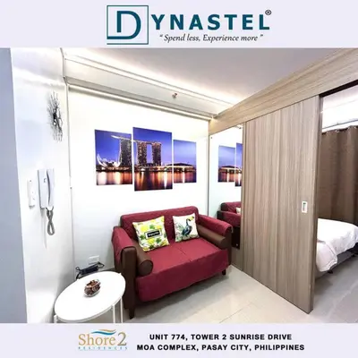 a room with a couch and a bed in it at MALL OF ASIA 774 DYNASTEL SHORE Staycation in Manila