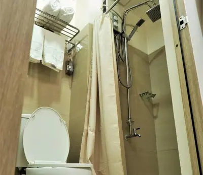 a bathroom with a toilet and a shower at MALL OF ASIA 774 DYNASTEL SHORE Staycation in Manila