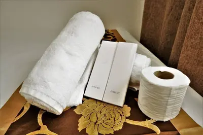 two towels and a roll of toilet paper on a table at CONDOTEL STAYCATION 793 Pasay DYNASTEL in Manila