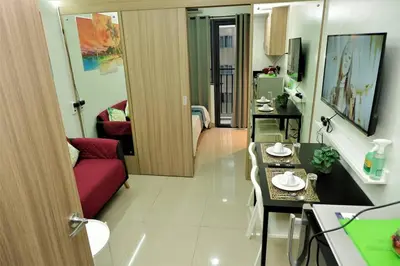a small living room with a red couch in a room at CONDOTEL STAYCATION 793 Pasay DYNASTEL in Manila