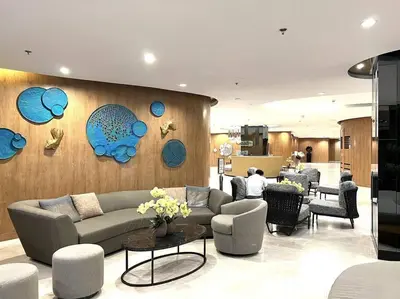 a living room with a couch and some chairs at DYNASTEL 787 SHORE Staycation in Manila