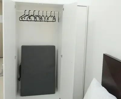 a room with a tv and a speaker on a wall at DYNASTEL 787 SHORE Staycation in Manila