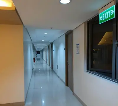 an empty hallway in a building with a sign on the wall at NAIA AIRPORT MOA 1278 DYNASTEL SHORE Staycation in Manila