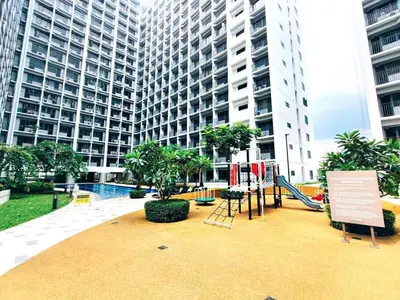 a playground in front of a tall building at NAIA AIRPORT MOA 1278 DYNASTEL SHORE Staycation in Manila