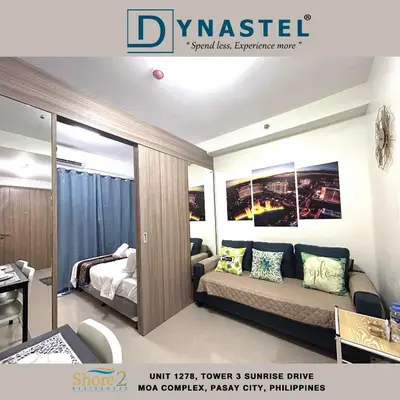 a living room with a couch and a bed at NAIA AIRPORT MOA 1278 DYNASTEL SHORE Staycation in Manila