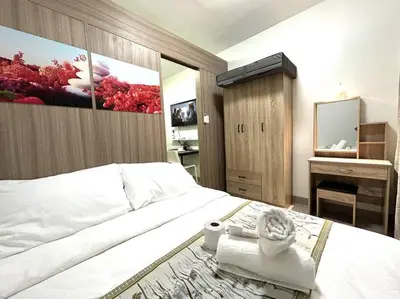 a bedroom with a large bed with a large painting on the wall at MOA PASAY 1478 Dynastel Shore Staycation in Manila