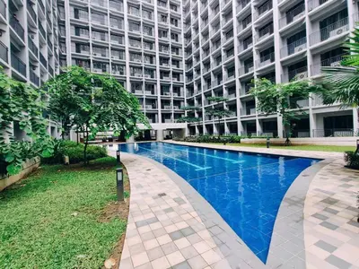 a large building with a swimming pool in front of it at MOA PASAY 1478 Dynastel Shore Staycation in Manila