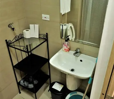 a small bathroom with a sink and a mirror at MOA PASAY 1478 Dynastel Shore Staycation in Manila