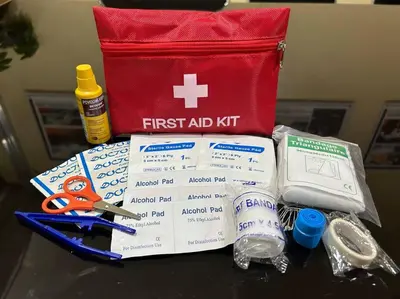 a red first aid kit with scissors and other items on a table at Pasay MOA 1486 Dynastel Shore Staycation in Manila