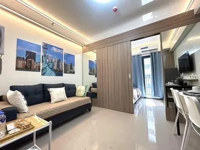 a living room with a couch and a table at Pasay MOA 1486 Dynastel Shore Staycation in Manila