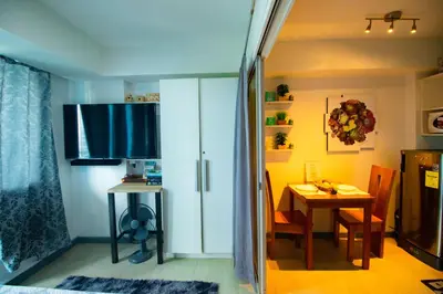 a kitchen with a table and a dining room at Cozy Chic Condotel Azure Urban Resort Residences in Manila