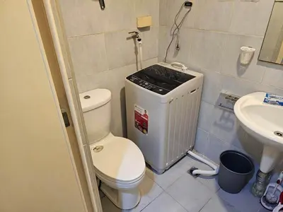 a small bathroom with a toilet and a sink at MOA Condo by Ashti in Manila