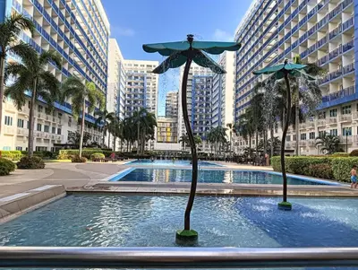 a statue of a umbrella in a pool in a city at MOA Condo by Ashti in Manila