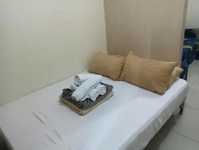 a bed with towels and pillows on it at MOA Condo by Ashti in Manila