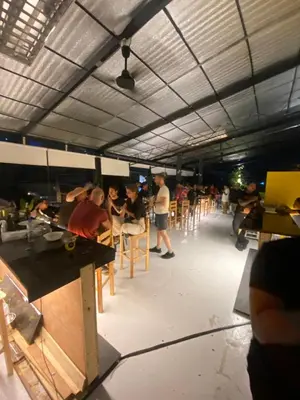a group of people sitting at tables in a building at Lime Lite Manila Hostel in Manila