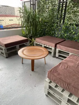 a group of benches and a table on a patio at Lime Lite Manila Hostel in Manila