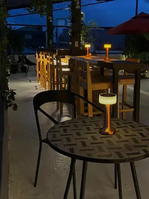 a table and chairs with candles on top at Lime Lite Manila Hostel in Manila