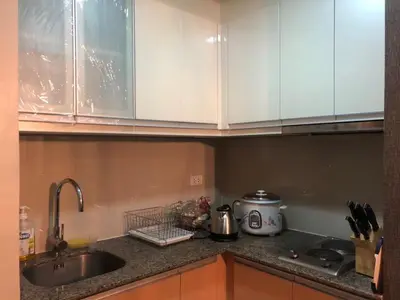 a kitchen with a sink and a counter top with a counter top at Modern Studio at NAIA Terminal 3 in Manila