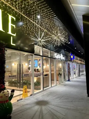 a store front with christmas lights on the ceiling at cozy studio unit at fame residence metro manila in Manila