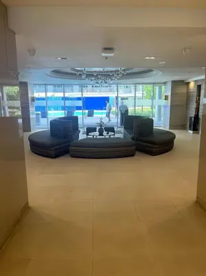 a lobby with couches and a table in a building at cozy studio unit at fame residence metro manila in Manila