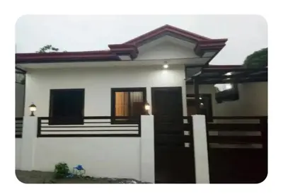 a small white house with a staircase in front of it at Kame House in Bacoor