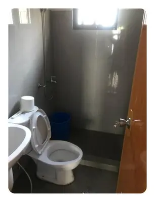 a bathroom with a toilet and a sink at Kame House in Bacoor
