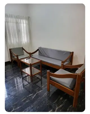 three chairs and a bed in a room at Kame House in Bacoor