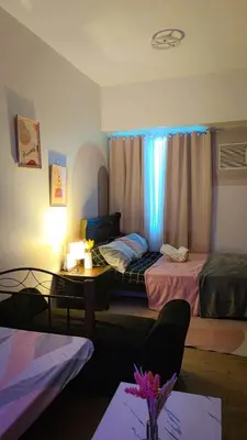 a hotel room with two beds and a table at anuva residences room 1 in Manila