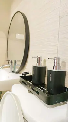 a bathroom with a mirror and two cups on a counter at anuva residences room 1 in Manila