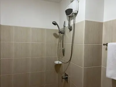 a shower with a shower head in a bathroom at GRAND RIEVERA SUiTES in Manila