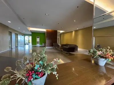 a lobby with two potted plants on a table at GRAND RIEVERA SUiTES in Manila
