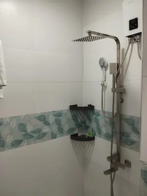 a shower in a bathroom with a shower head at 6 Guest - Unit 2 Studio type in Santa Rosa