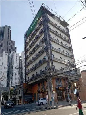 a tall building on the corner of a city street at St. Marvin Studio Makati M408 in Manila