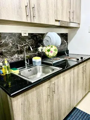 a kitchen with a sink and a counter top at aesthetic suite in edsa smdc fame VERY FAST WIFI in Manila