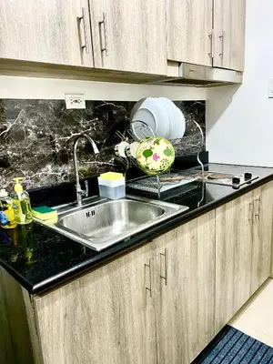a kitchen with a sink and a counter top at aesthetic suite in edsa smdc fame VERY FAST WIFI in Manila