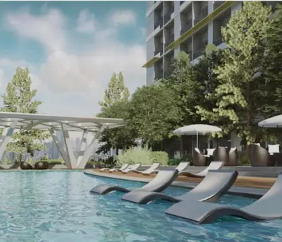 a swimming pool with lounge chairs and umbrellas at aesthetic suite in edsa smdc fame VERY FAST WIFI in Manila
