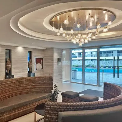a living room with a chandelier in a building at aesthetic suite in edsa smdc fame VERY FAST WIFI in Manila