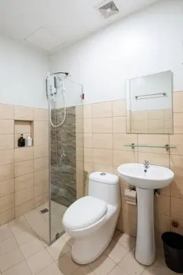 a bathroom with a toilet and a sink and a shower at St. Marvin Studio Makati M405 in Manila