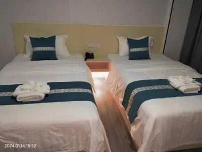 a hotel room with two beds with towels on them at Venice Star Grand Hotel in Manila
