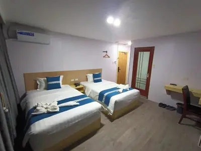a hotel room with two beds with towels on them at Venice Star Grand Hotel in Manila