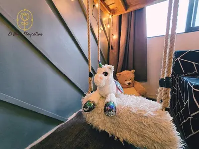 two stuffed animals sitting on a rope swing at El Nissi Staycation, FAMILY CABIN, CONTEMPORARY CABIN, Enchanted Kingdom in Santa Rosa