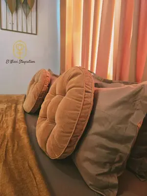 a pillow sitting on top of a bed at El Nissi Staycation, FAMILY CABIN, CONTEMPORARY CABIN, Enchanted Kingdom in Santa Rosa