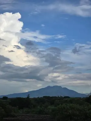 a cloudy sky with mountains in the distance at El Nissi Staycation, FAMILY CABIN, CONTEMPORARY CABIN, Enchanted Kingdom in Santa Rosa