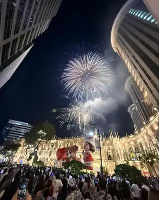 a crowd of people looking at a fireworks display at Cozy Corner Haven near Venice Grand Canal Mall in Manila