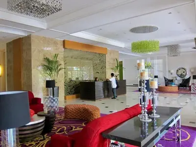 a person standing in a room with a living room at Cozy Corner Haven near Venice Grand Canal Mall in Manila